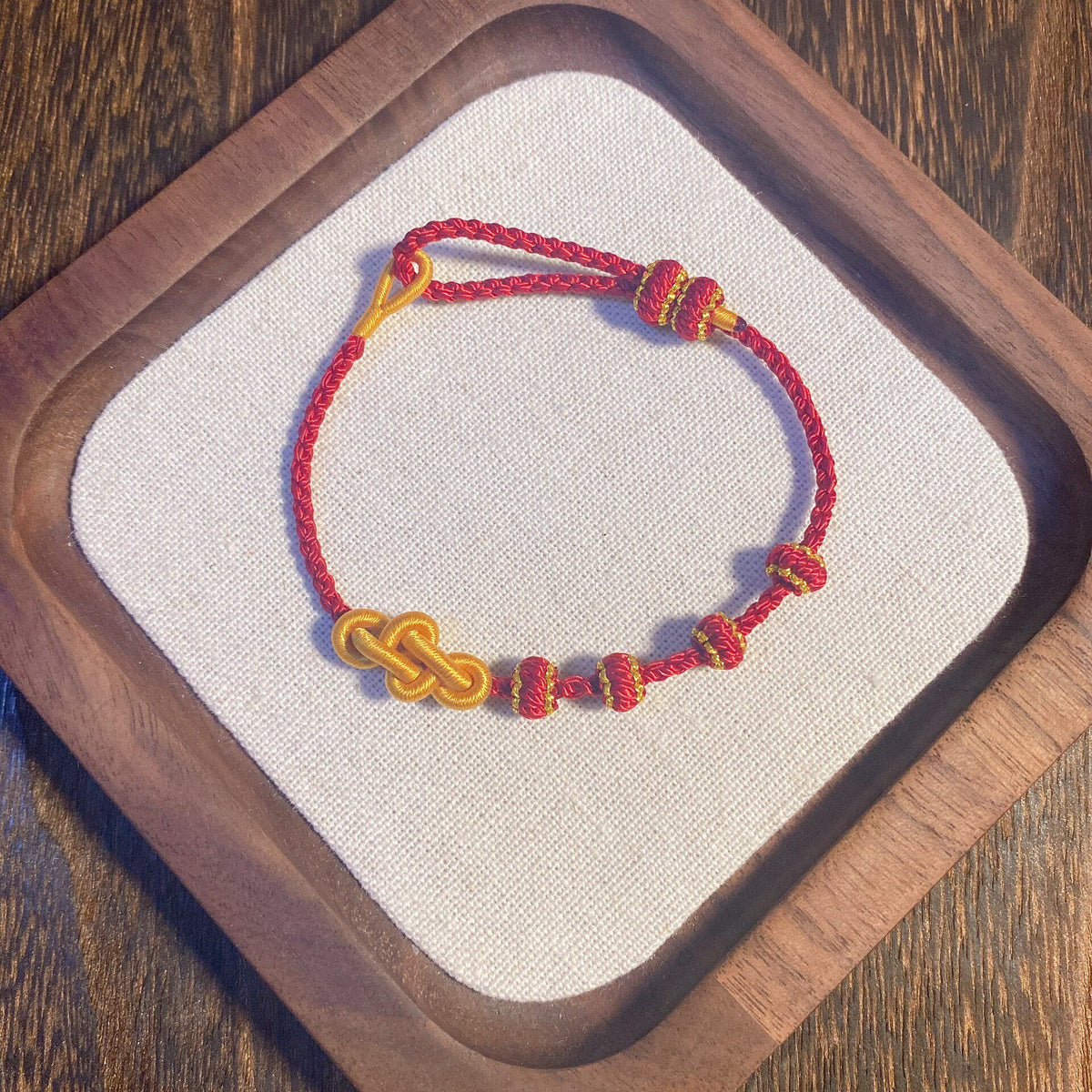 Handcrafted Red Braided Bracelet with Gold Knots