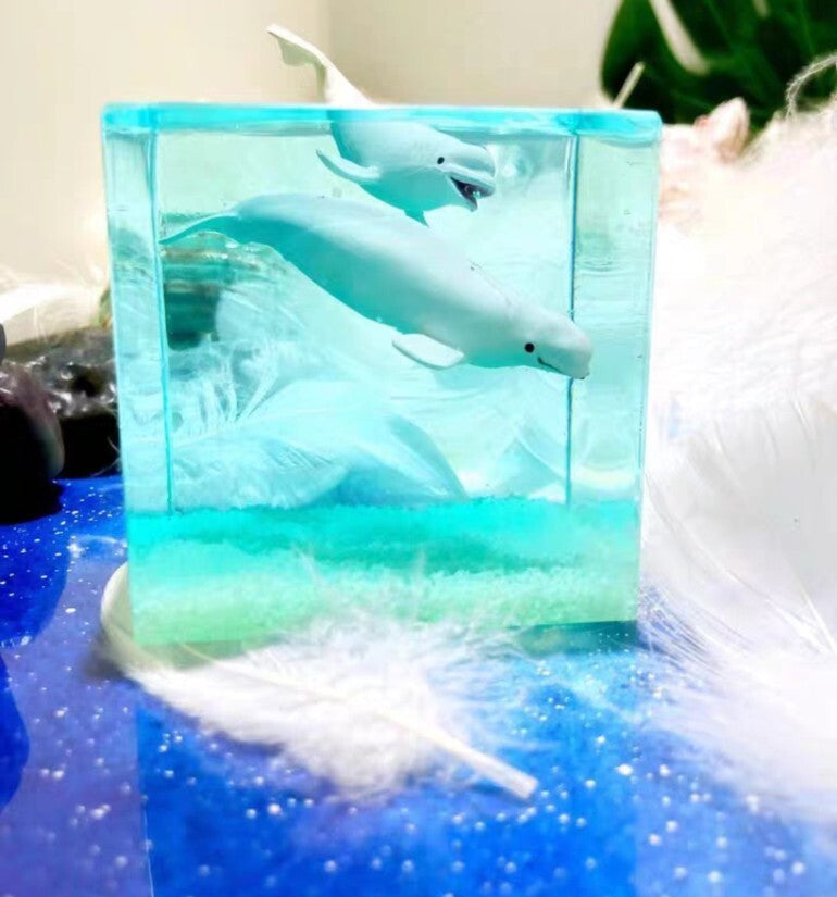 Two Dolphin Figurines Glowing Resin Block