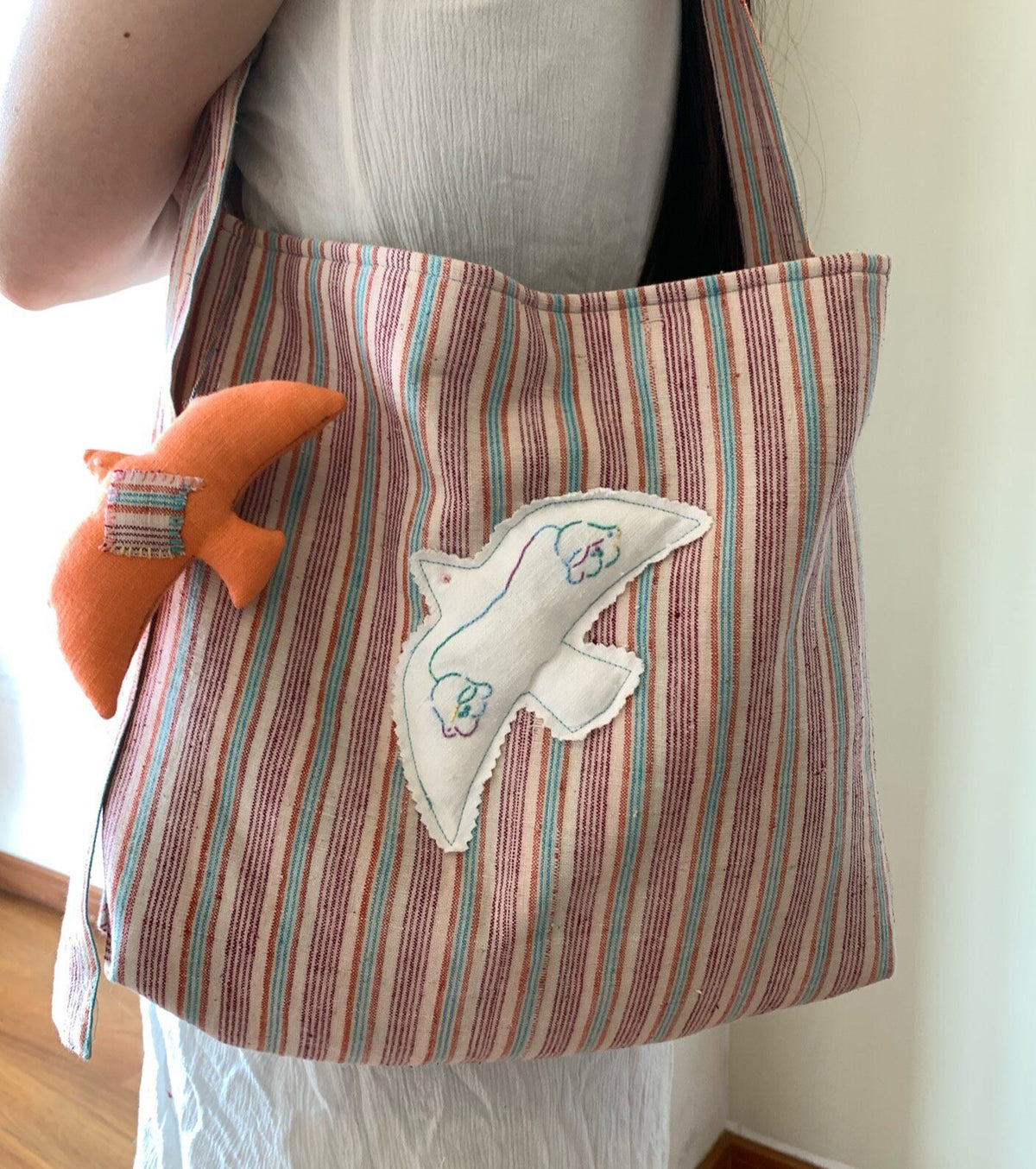 Handwoven Striped Shoulder Bag with Bird Applique