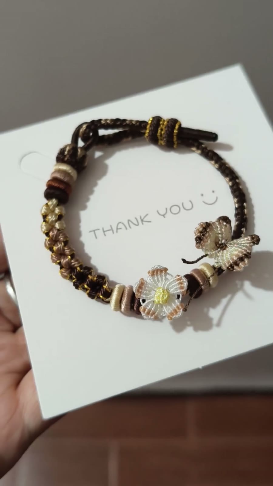 Handflätat armband i snöre svart guld blomma