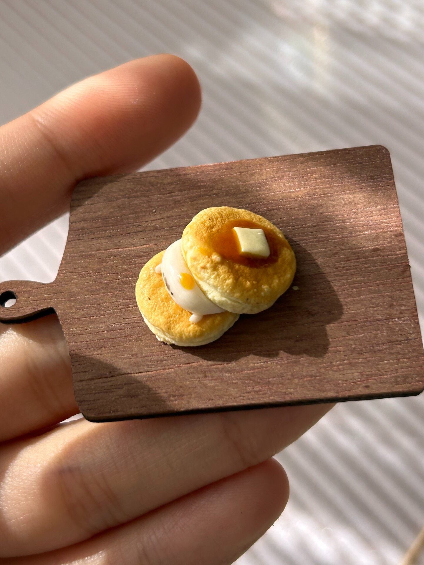 Miniature Pancake Stack with Seal Figurine on Wooden Board