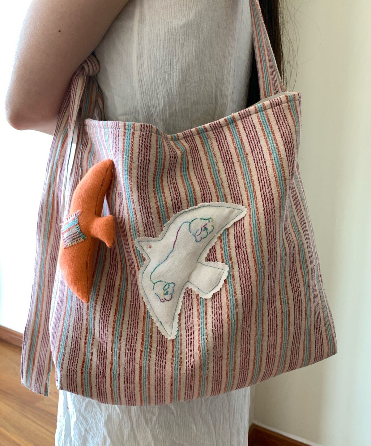 Handwoven Striped Shoulder Bag with Bird Applique