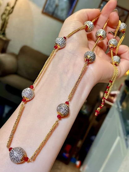Gold-Tone Multi-Strand Necklace with Pavé-Set Round Beads and Red Gemstone Accents