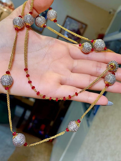 Gold-Tone Multi-Strand Necklace with Pavé-Set Round Beads and Red Gemstone Accents