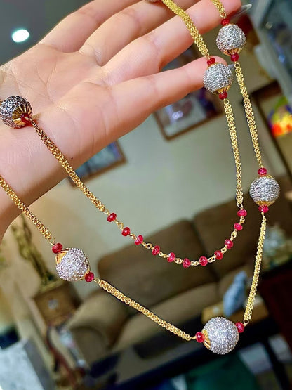 Gold-Tone Multi-Strand Necklace with Pavé-Set Round Beads and Red Gemstone Accents