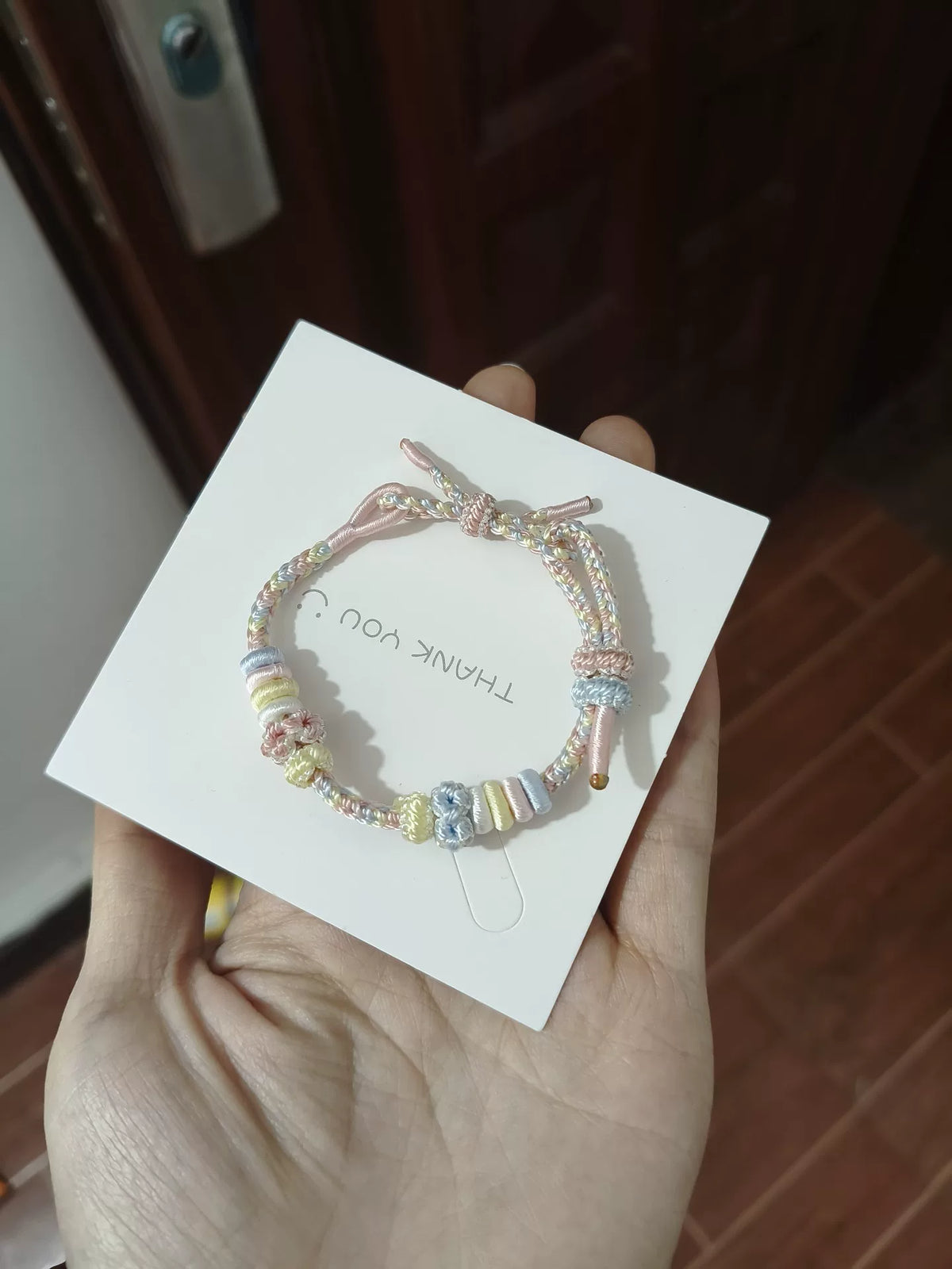 Braccialetto intrecciato arcobaleno con nodi a fiore
