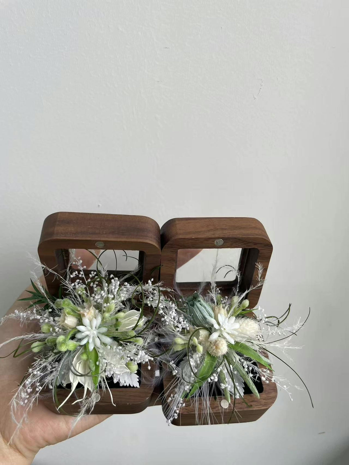 Vitaitt och gröna blomsterringar i par