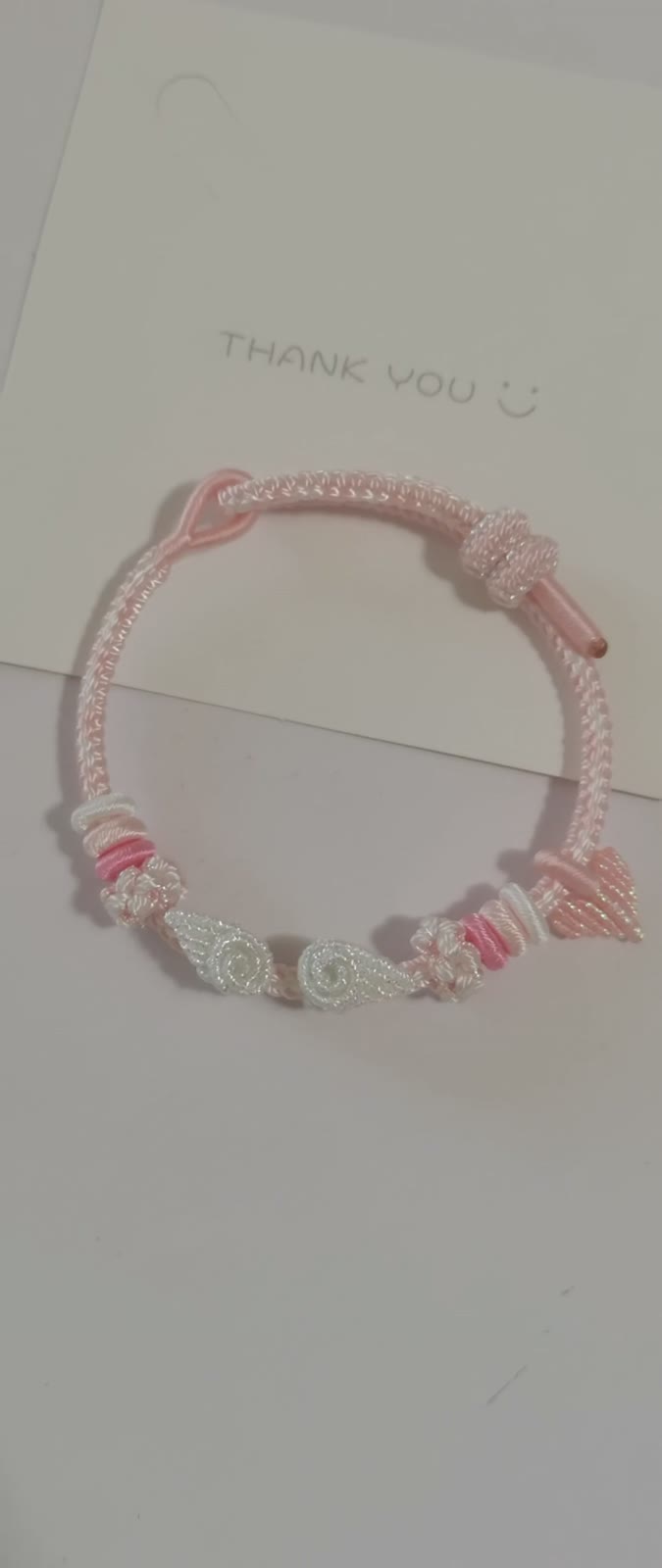 Braccialetto con sfumatura rosa e bianca, fiore e fiocco