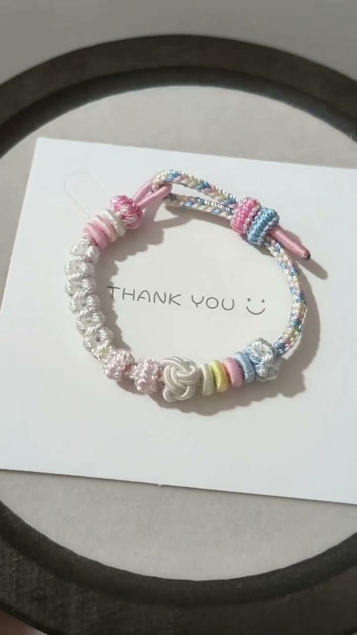 Pulseira de Cordão Tecida à Mão com Gradiente Pastel e Nós em Flor