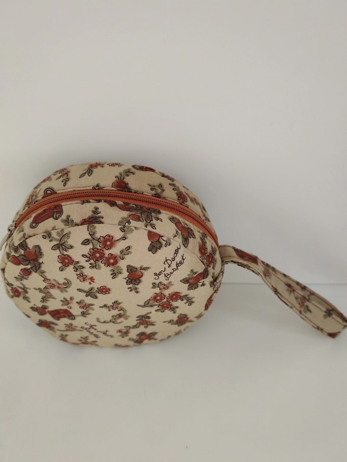 Estuche redondo floral con correa de muñeca