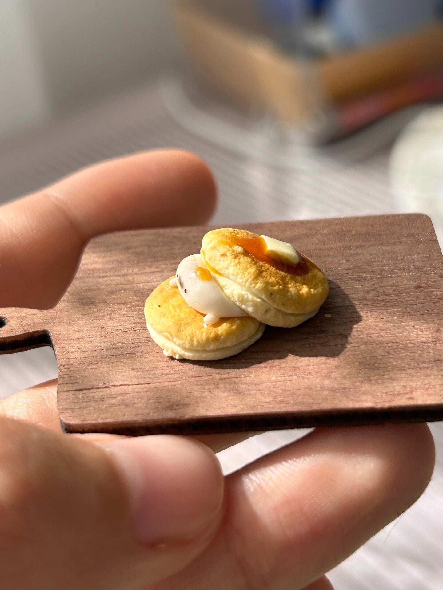Miniature Pancake Stack with Seal Figurine on Wooden Board