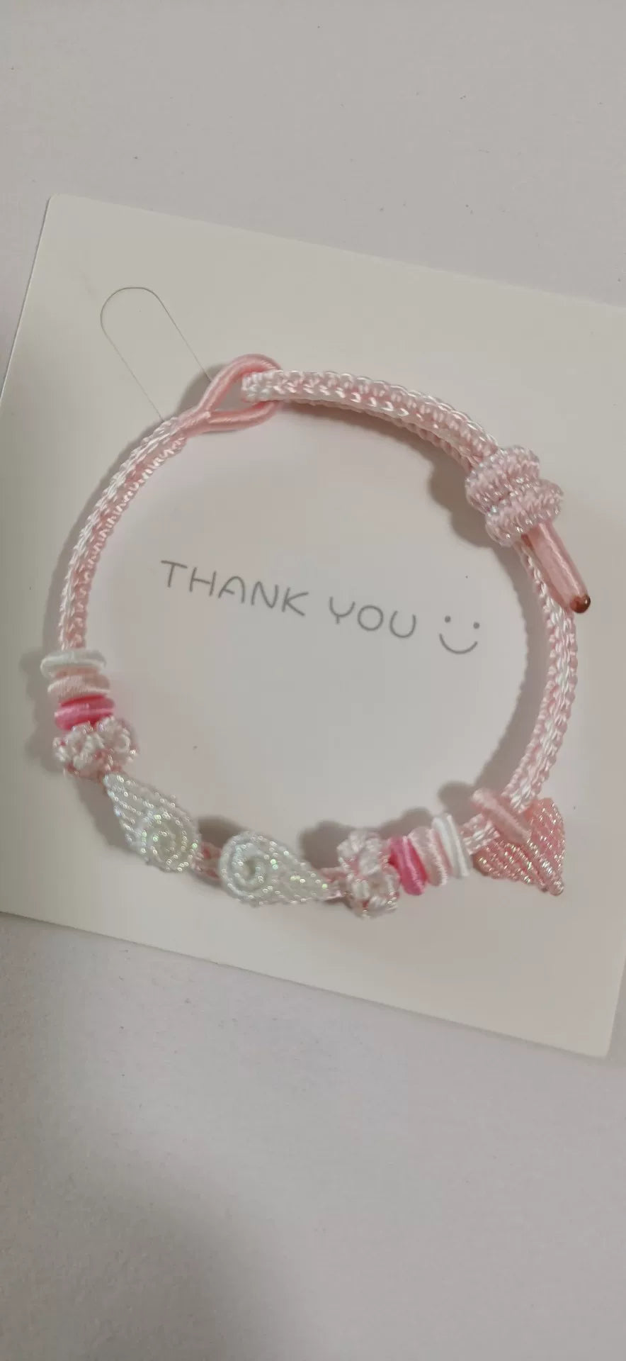 Braccialetto con sfumatura rosa e bianca, fiore e fiocco