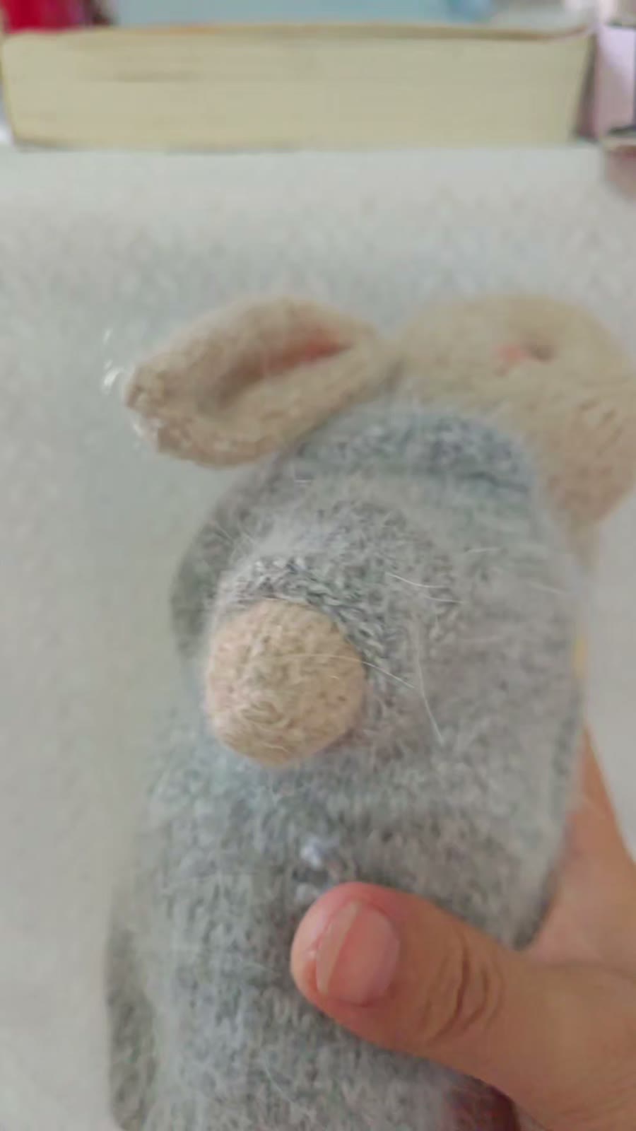 Handgestricktes Hasen-Spielzeug mit grauem Pullover