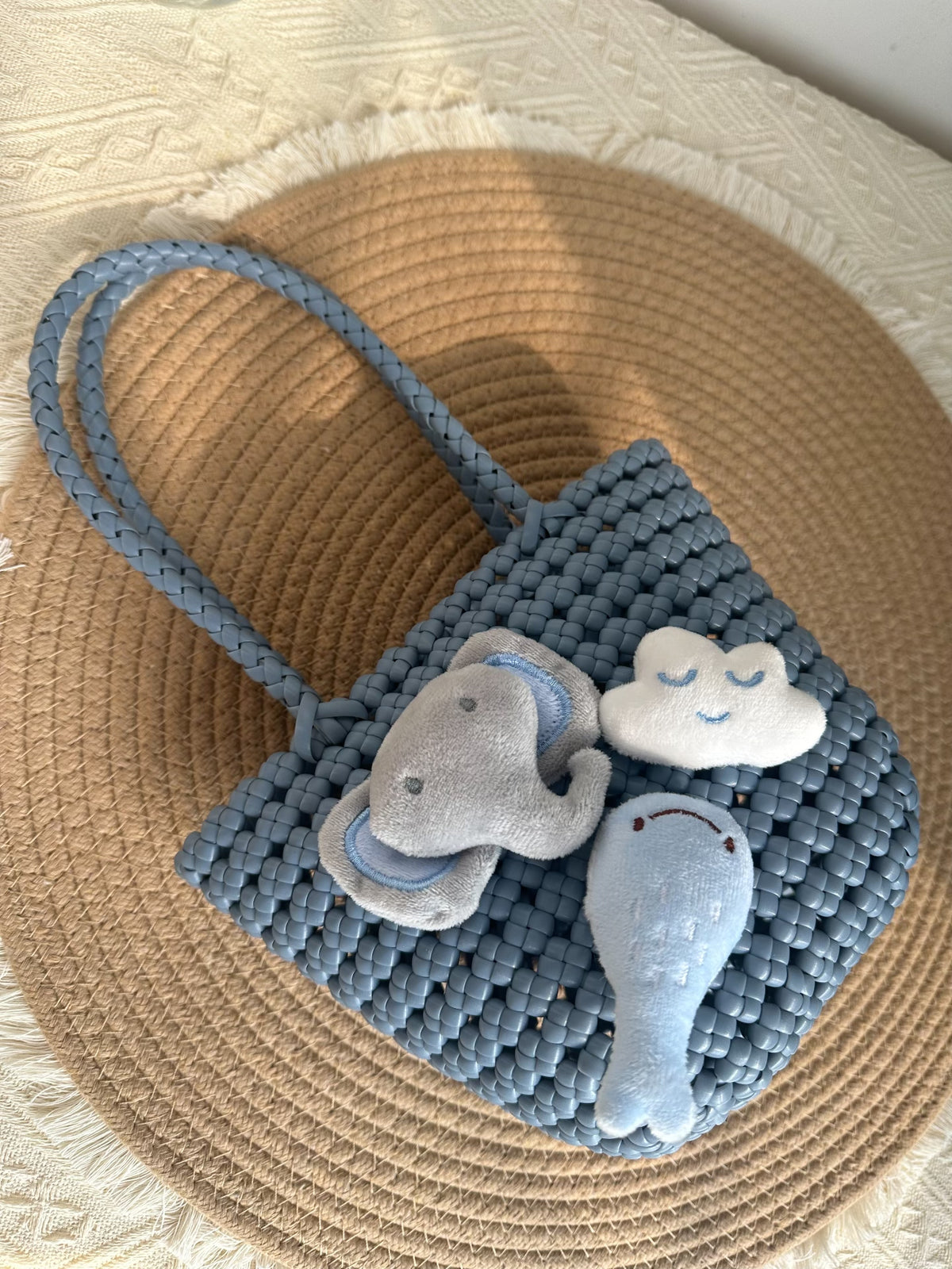 Sac en osier tressé bleu brumeux avec trois charms en peluche