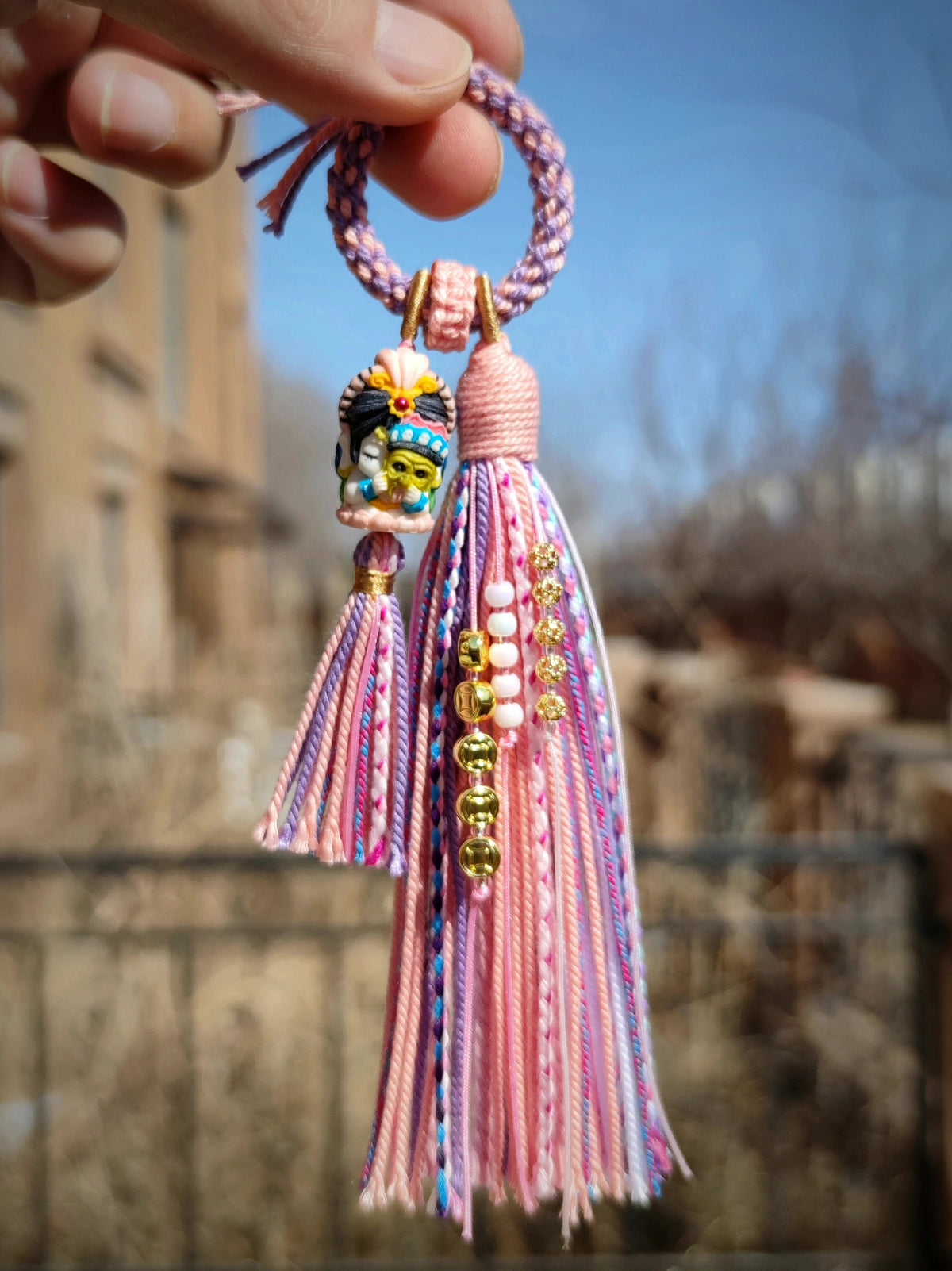 Handwoven Tassel Charm with Multi-Faced Figure