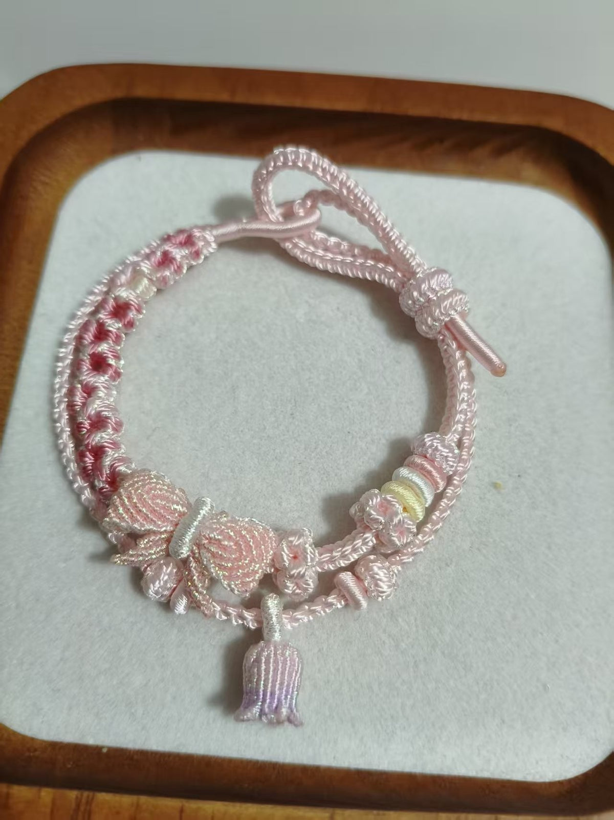 Handwoven Pink Gradient Bracelet with Floral Decor