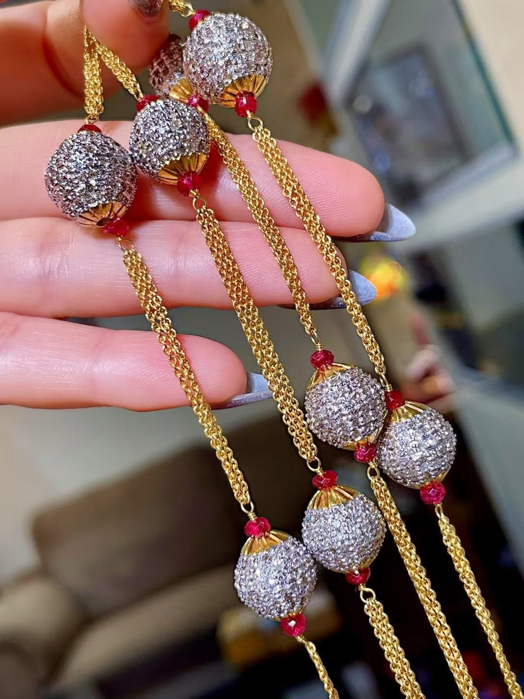 Gold-Tone Multi-Strand Necklace with Pavé-Set Round Beads and Red Gemstone Accents