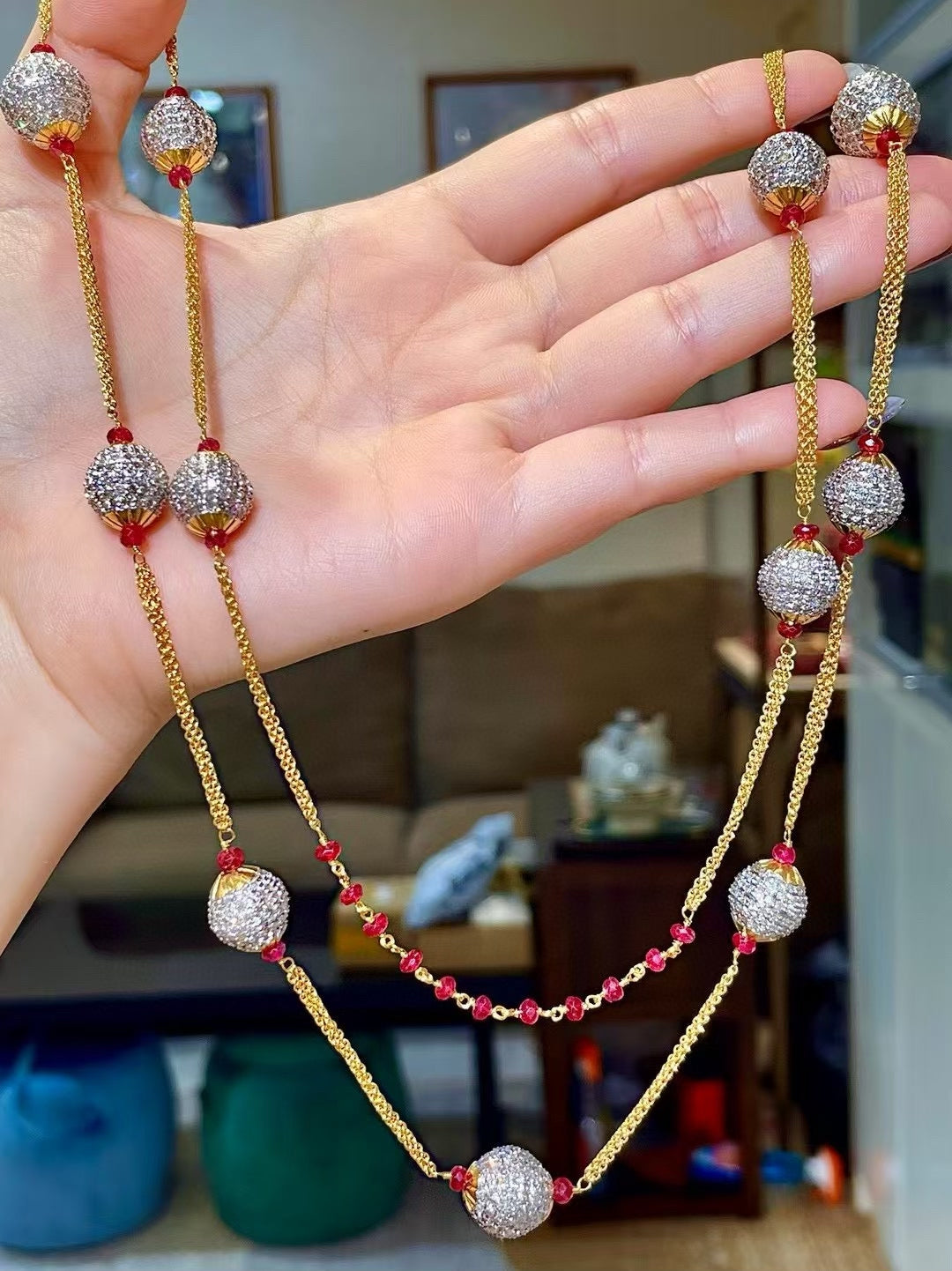 Gold-Tone Multi-Strand Necklace with Pavé-Set Round Beads and Red Gemstone Accents