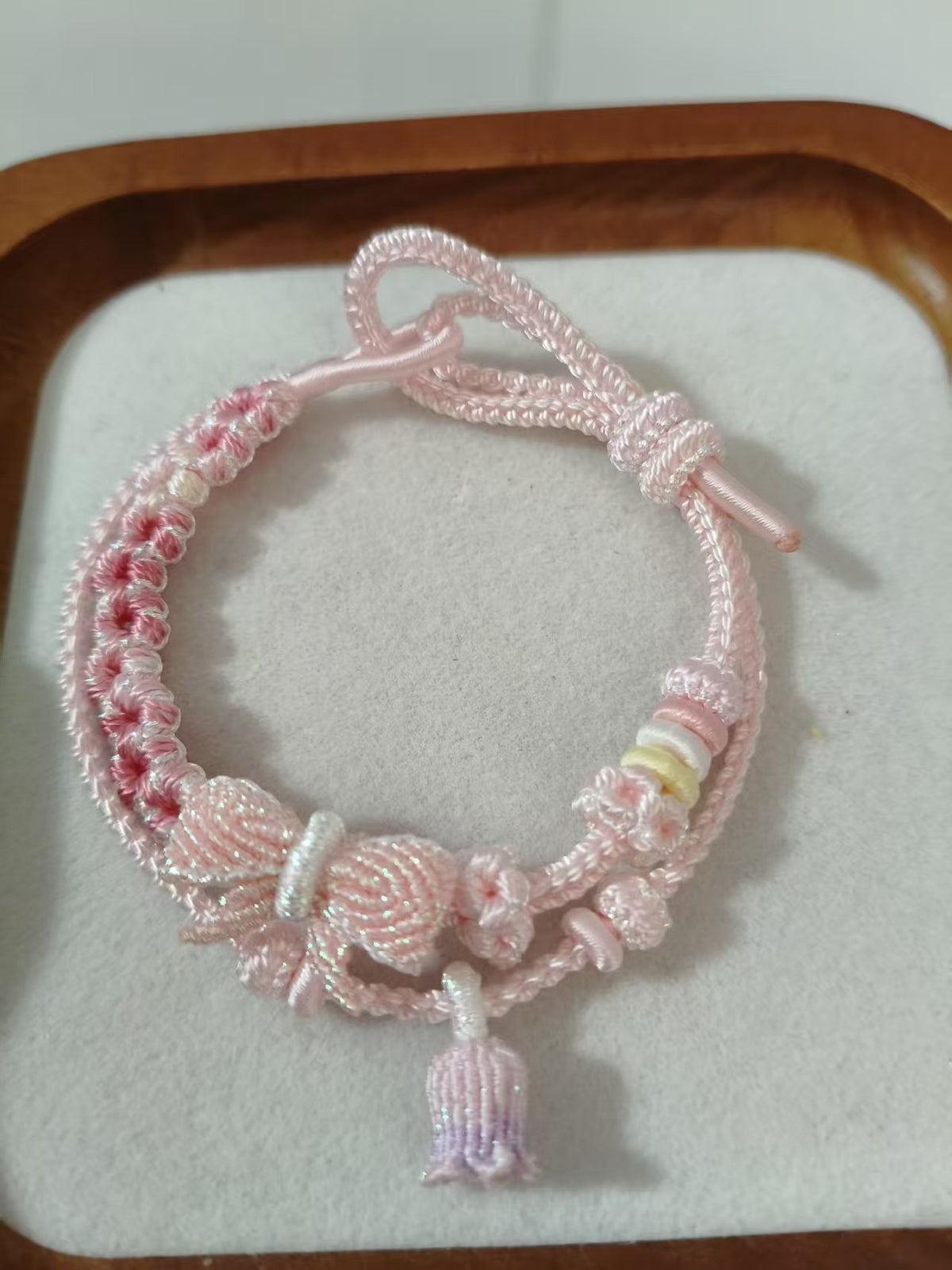 Handwoven Pink Gradient Bracelet with Floral Decor