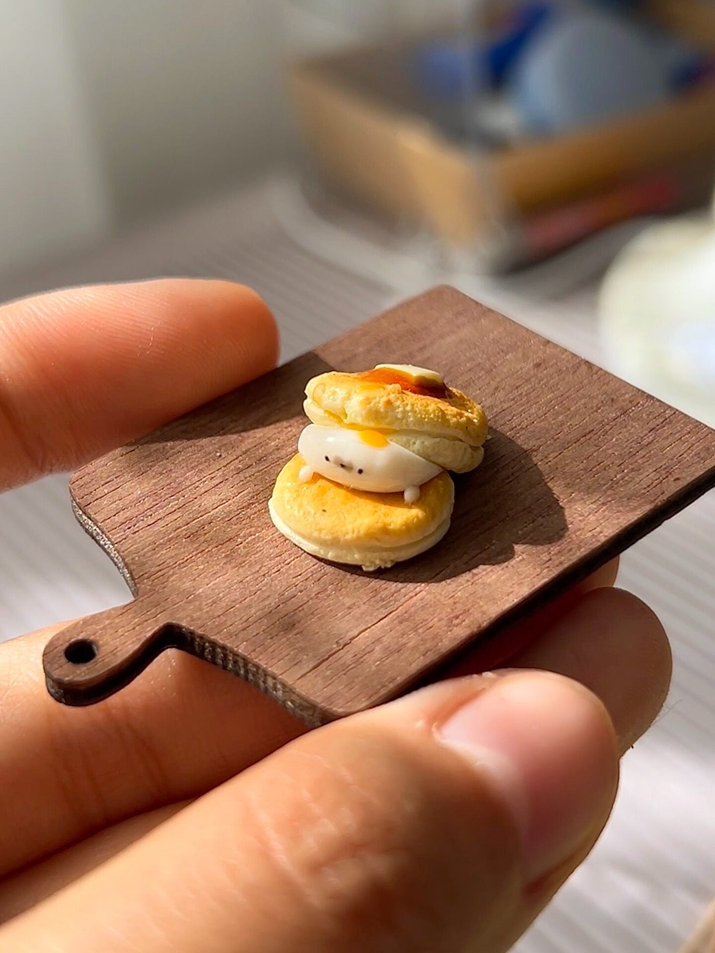 Miniature Pancake Stack with Seal Figurine on Wooden Board